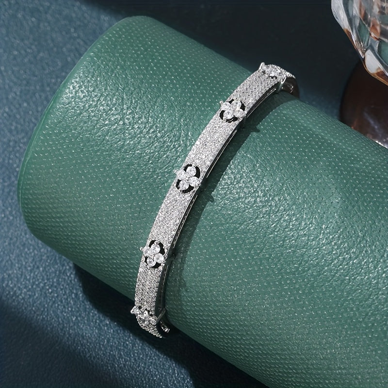 Gouden bangle armband met bloemen en zirkonia