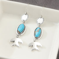 Zilveren oorbellen met ovale turquoise en vogelhanger