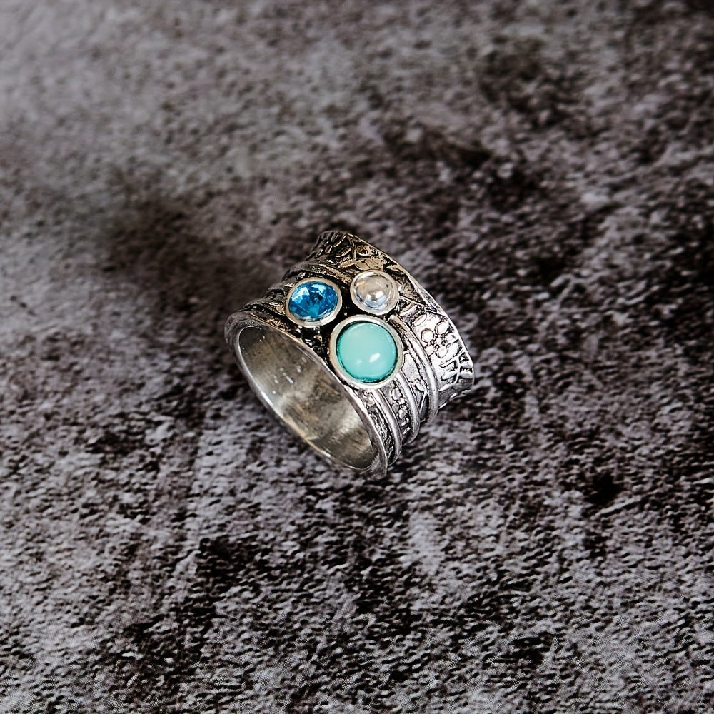 Zilveren spinner ring met blauwe edelstenen