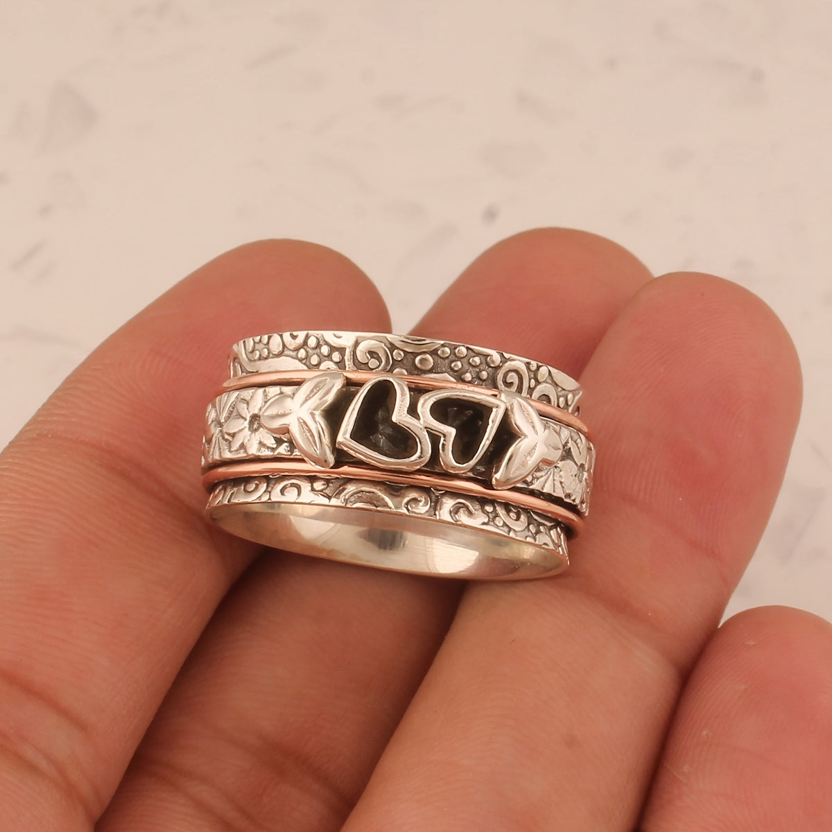 Zilveren spinner ring met hartjes en bloemen