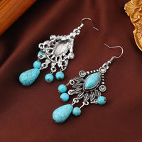 Zilveren bohemian oorbellen met turquoise kralen en bedels