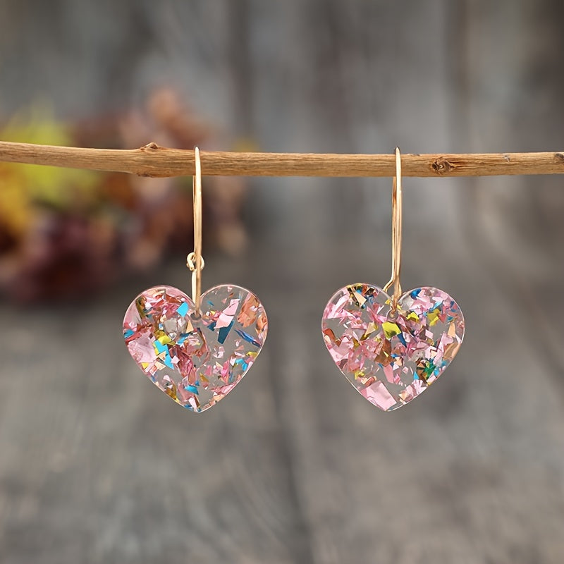 Gouden oorbellen met hart van roze confettihars