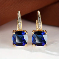 Gouden oorbellen met blauwe kussensteen