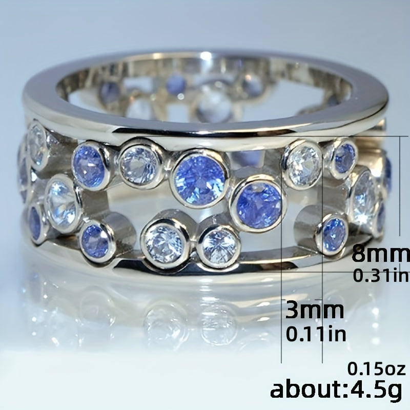 Brede zilveren ring met blauwe en witte zirkonia