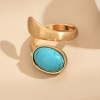 Gouden bypass ring met ovale turquoise steen