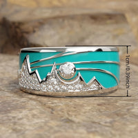 Zilveren ring met turquoise emaille berg-zonmotief en zirkonia