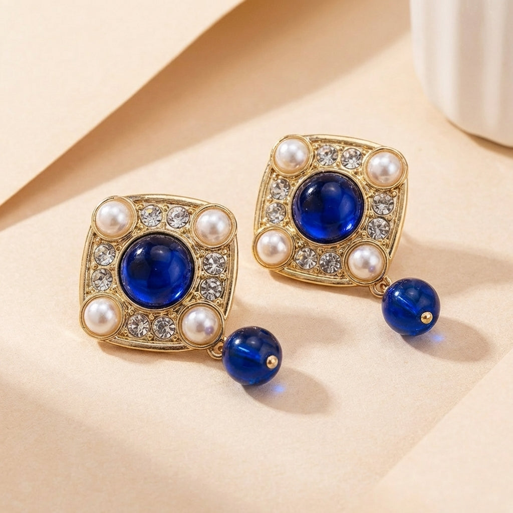 Gouden vintage oorbellen met blauwe steen en parels