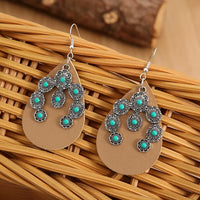 Western bruine leren oorbellen met turquoise bloemen