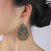 Western bruine leren oorbellen met turquoise bloemen