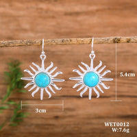 Gouden bohemian oorbellen met turquoise zon