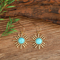Gouden bohemian oorbellen met turquoise zon
