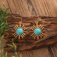 Gouden bohemian oorbellen met turquoise zon