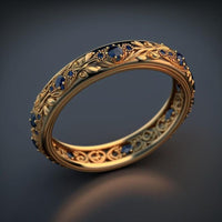 Gouden eternity-ring met blauwe stenen en bladmotief
