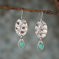 Zilveren botanische oorbellen met turquoise druppel