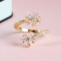 Gouden open ring met twee zirkonia bloemen