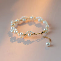 Gouden armband met parelclusters en hangbedeltje