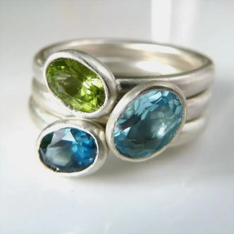 Zilveren ringenset met groene en blauwe edelstenen