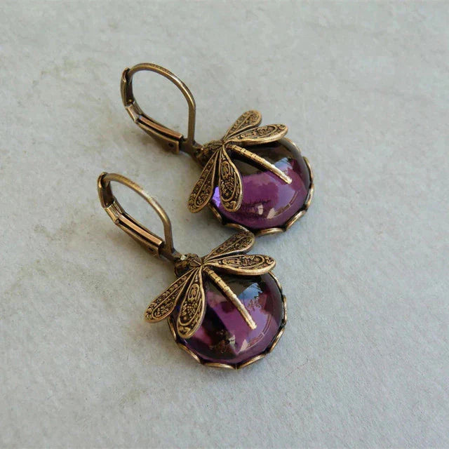Vintage oorbellen met libelle en blauwe steen