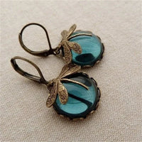 Vintage oorbellen met libelle en blauwe steen