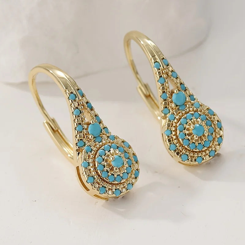 Gouden vintage oorbellen met turquoise rozet