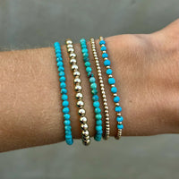 Set van turquoise en gouden kralenarmbanden