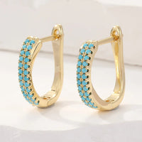 Gouden huggie-oorbellen met turquoise pavé