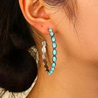 Zilveren oorbellen met ovale turquoise stenen