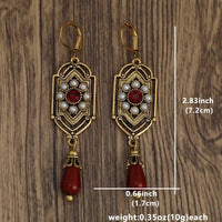 Gouden vintage oorbellen met parels en rode druppel