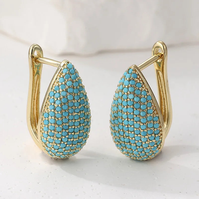 Gouden druppeloorbellen met turquoise pavé