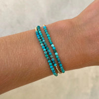 Set van turquoise en gouden kralenarmbanden