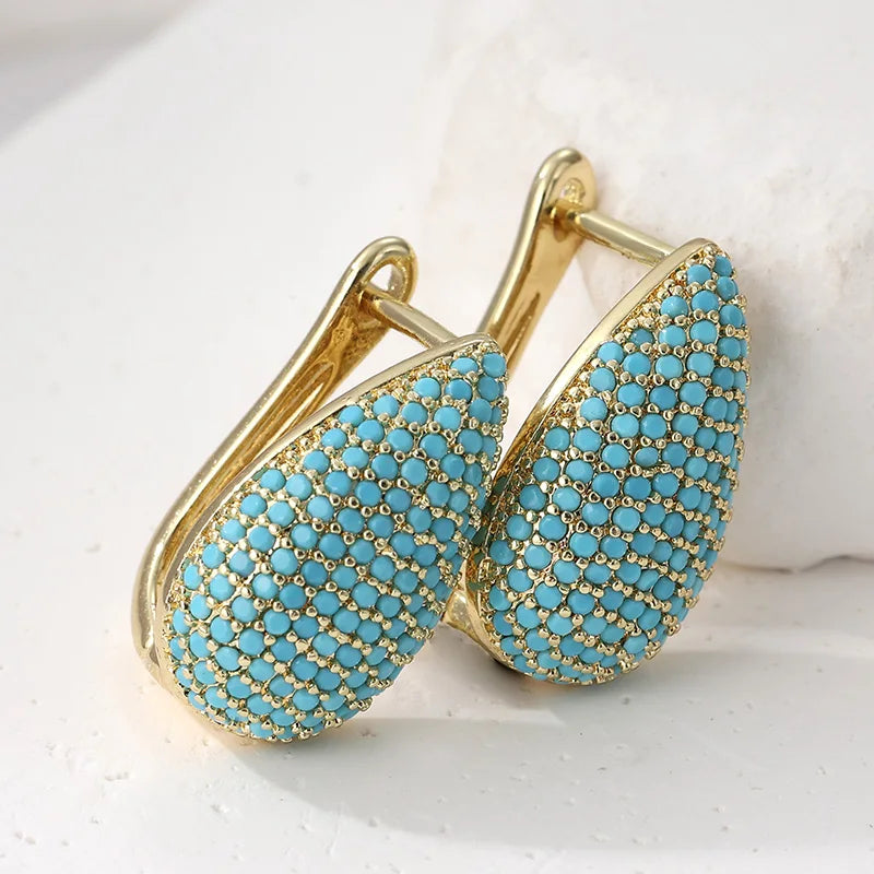 Gouden druppeloorbellen met turquoise pavé