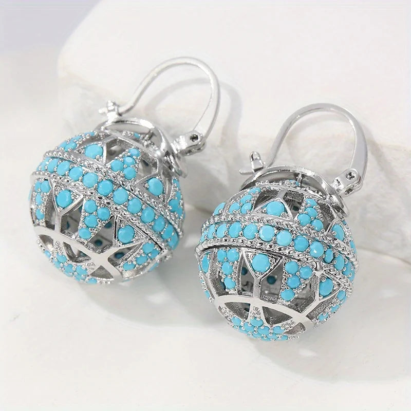 Gouden bolhanger-oorbellen met turquoise kralen
