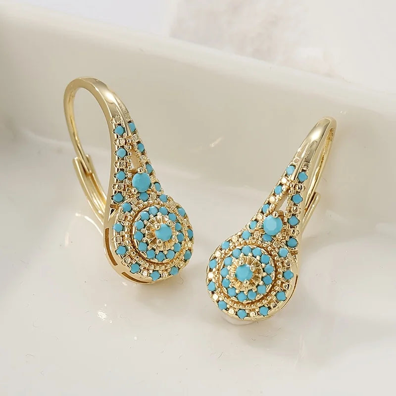 Gouden vintage oorbellen met turquoise rozet