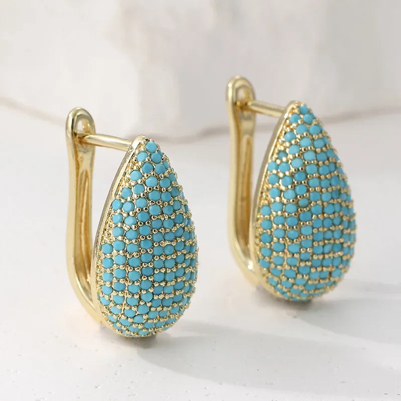 Gouden druppeloorbellen met turquoise pavé