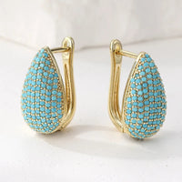 Gouden druppeloorbellen met turquoise pavé