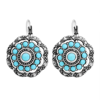 Zilveren oorbellen met turquoise bloem rozet