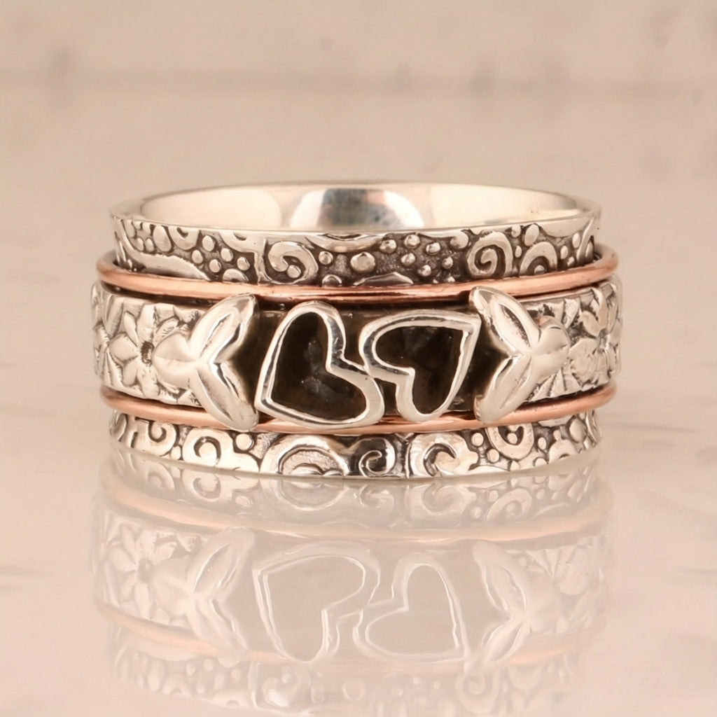 Zilveren spinner ring met hartjes en bloemen