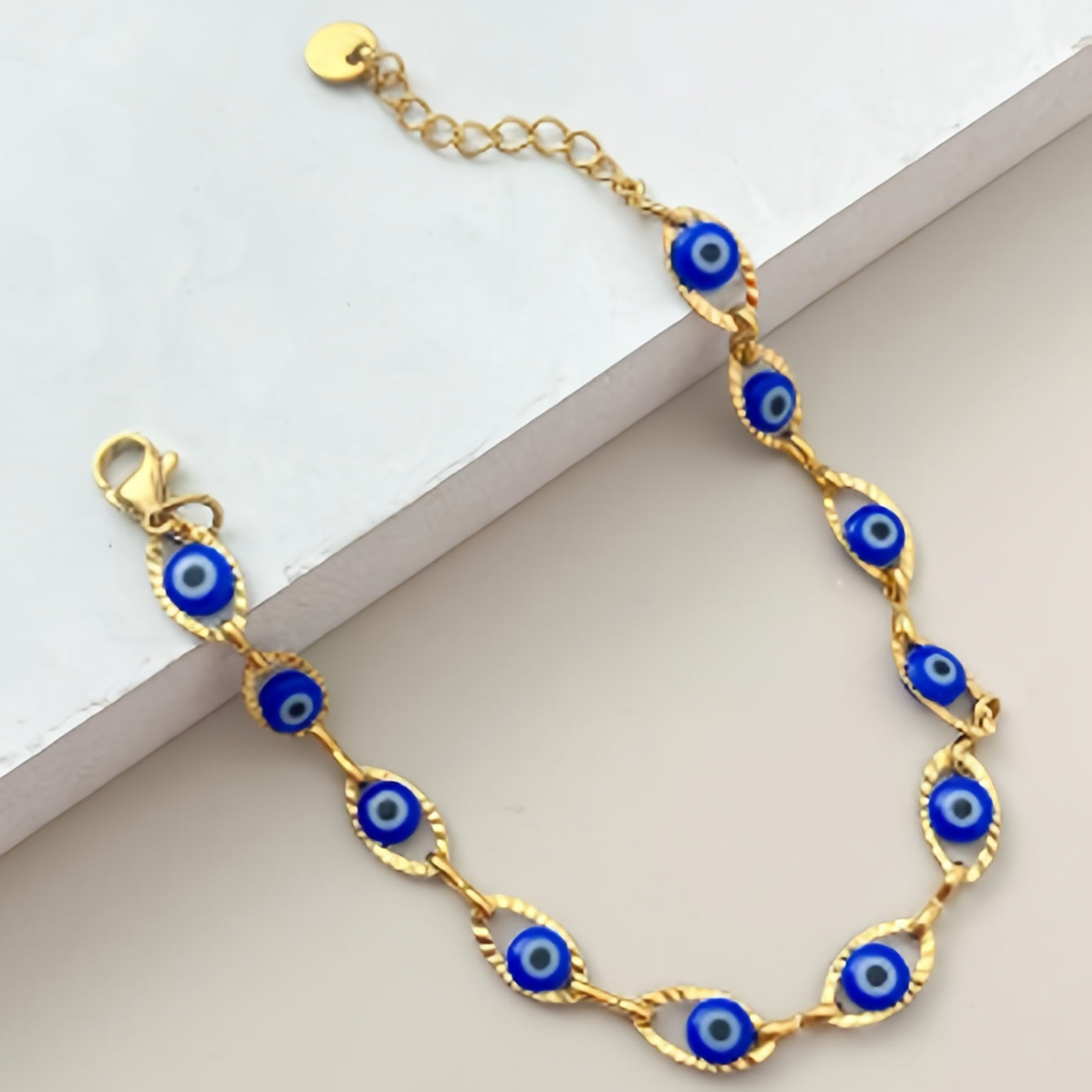 Gouden armband met blauwe boze oog kraaltjes
