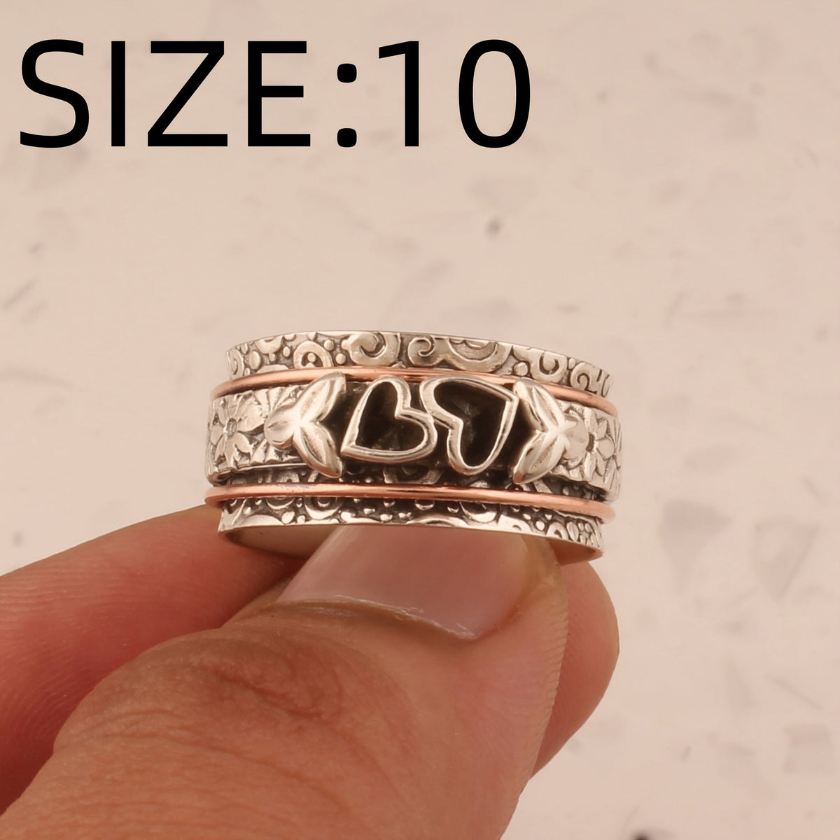 Zilveren spinner ring met hartjes en bloemen