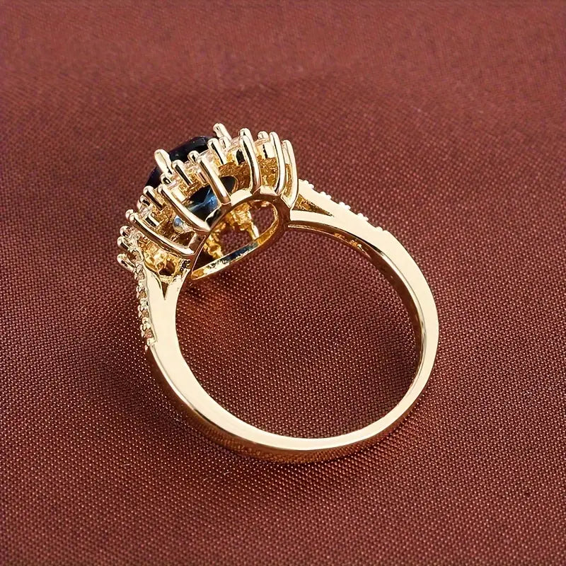 Gouden vintage ring met blauwe steen en zirkonia
