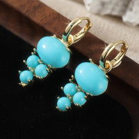 Gouden oorbellen met ovale turquoise en kraaltjes