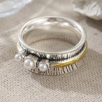 Zilveren ring met parels en goudkleurige spinner band