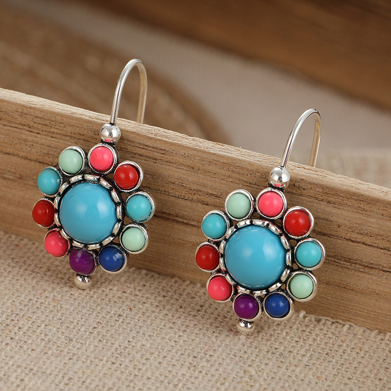 Zilveren oorbellen met turquoise bloemmotief
