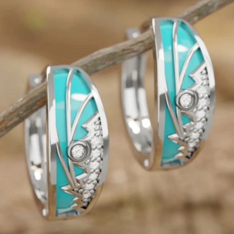 Zilveren oorbellen met turquoise emaille zonsopgangmotief