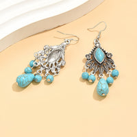 Zilveren bohemian oorbellen met turquoise kralen en bedels