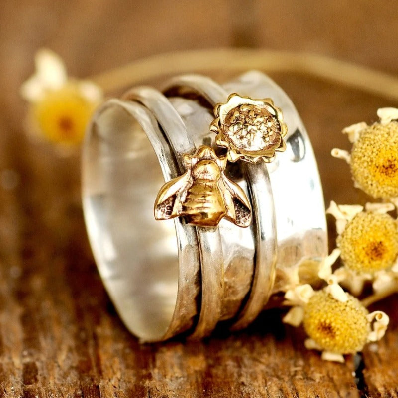 Zilveren spinner ring met gouden bij en bloem