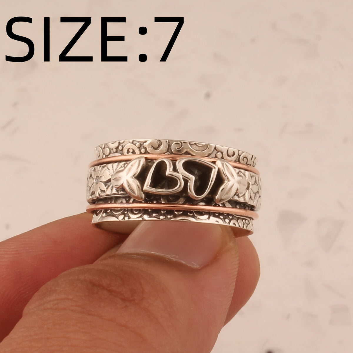 Zilveren spinner ring met hartjes en bloemen