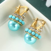 Vintage gouden oorbellen met turquoise parel