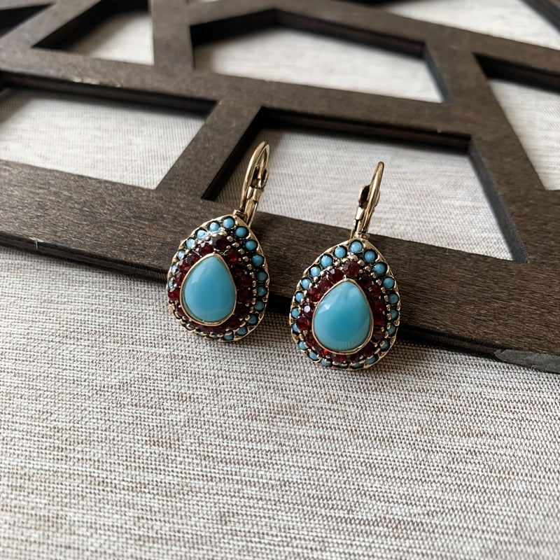 Vintage oorbellen met turquoise druppel en rode strass