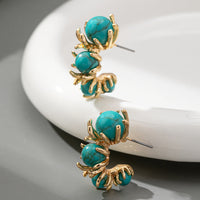 Gouden oorbellen met turquoise kralen